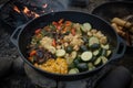 campfire cook, deftly turning tossed ingredients into delicious side dish