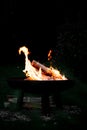 Campfire on a fire bowl, dark night background, barbecue camping Royalty Free Stock Photo