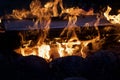 Campfire flame in the dark. Visible flames and hot coals. Close-up Royalty Free Stock Photo