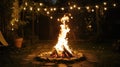 Campfire glow in backyard with string lights, cozy atmosphere Royalty Free Stock Photo