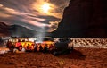 Campfire group and cars in Sahara Desert by night. Royalty Free Stock Photo