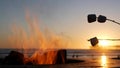 Campfire pit in California USA. Camp fire on ocean sea beach, roasting toast marshmallow on bonfire. Royalty Free Stock Photo