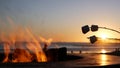 Campfire pit in California USA. Camp fire on ocean sea beach, roasting toast marshmallow on bonfire. Royalty Free Stock Photo