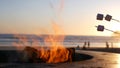 Campfire pit in California USA. Camp fire on ocean sea beach, roasting toast marshmallow on bonfire. Royalty Free Stock Photo