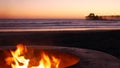 Campfire pit in California USA. Camp fire on twilight ocean beach, bonfire flame by sea water waves. Royalty Free Stock Photo