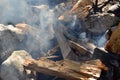 Campfire, smoke, wood and rocks. Stone and wood background nature texture