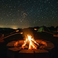 Campfire surrounded by a circle of bricks, with logs burning brightly. People Royalty Free Stock Photo