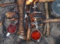 Campfire with tea and food in camping cookware Royalty Free Stock Photo