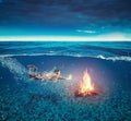 Campfire underwater. Young woman swims underwater Royalty Free Stock Photo