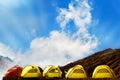 Campground in the mountains. Many yellow adn red tents against the blue sky with amazing clouds