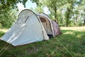 Campimg tent in pine forest in a summer day. Tourist camp Royalty Free Stock Photo