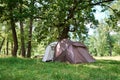 Campimg tent in pine forest in a summer day. Tourist camp Royalty Free Stock Photo
