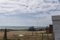 Camping area surrounded by cars and the sea under a cloudy sky in Cadiz, Spain