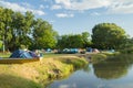 Camping area with tents near river