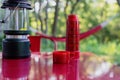 Camping background with thermos and cup on a camp table