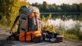 Camping backpack, elements and equipment in a forest lawn