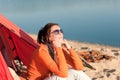 Camping beach woman by campfire in tent Royalty Free Stock Photo