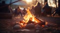 Camping bonfire with people on background at sunset. Camping concept