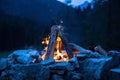 Camping bonfire with yellow and red flames in summer, forest. Copy space