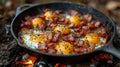 Camping breakfast with bacon and eggs in a cast iron skillet. Royalty Free Stock Photo