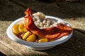 Camping breakfast bowl with potatoes, bacon, and sausage gravy