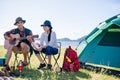 Camping camp in nature happy friends party and playing guitar to Royalty Free Stock Photo