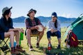 Camping camp in nature happy friends sitting discuss together in summer Royalty Free Stock Photo