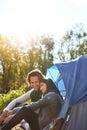 Camping can be far more romantic than your average dinner. an adventurous young couple at their campsite.