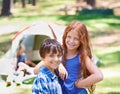 Camping, children and happy in portrait while outside, bonding and freedom in outdoor adventure. Kids, face and smiling Royalty Free Stock Photo