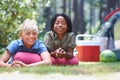 Camping, children and relaxing in portrait on grass, bonding and happy for outdoor adventure. Kids, face and smiling Royalty Free Stock Photo