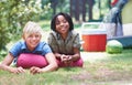 Camping, children and relaxing in portrait on ground, bonding and boys in outdoor adventure. Happy kids, face and Royalty Free Stock Photo