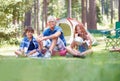 Camping, children and relaxing in portrait while outside, bonding and happy for outdoor adventure. Kids, face and eating Royalty Free Stock Photo