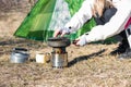 Camping and cooking. woman hiker cooking lunch in front of her tent in nature Royalty Free Stock Photo