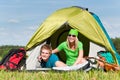 Camping couple lying inside tent summer