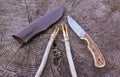 Camping damascus blade knife, sheath and sticks on wood log Royalty Free Stock Photo