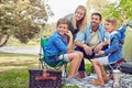Camping is a family pasttime. a family of four camping in the woods. Royalty Free Stock Photo