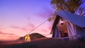 Camping with fire.Evening scence.Tent under the big tree on a meadow,hill,mountains. Royalty Free Stock Photo