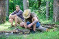 Camping in forest. Men on vacation. Man brutal bearded hipster prepares bonfire in forest. Ultimate guide to bonfires