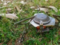 camping gas stove on the grass. portable lightweight stove for hiking, camping, and backpacking.