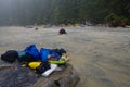 Camping gear on a boulder on beach in the fog