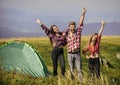 Camping gear. Camping tent. Feel freedom. Happiness concept. Hiking activity. Friends set up tent on top mountain