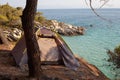 Camping grey tent on the edge of a cliff above the sea