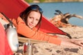 Camping happy woman in tent by campfire Royalty Free Stock Photo