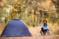 Camping holiday, tourist traveler woman in sweater and black hat ralaxing in camp tent in forest, rest vacation concept Royalty Free Stock Photo