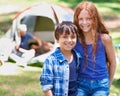 Camping, kids and happy in portrait while outside, bonding and carefree in outdoor adventure. Children, face and smiling Royalty Free Stock Photo