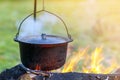 Camping kitchenware - pot on the fire at an outdoor campsite Royalty Free Stock Photo