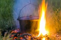 Camping kitchenware - pot on the fire at an outdoor campsite Royalty Free Stock Photo