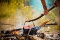 Camping kitchenware - pot on the fire at an outdoor campsite. Royalty Free Stock Photo