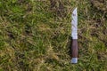 A camping knife laying in the grass Royalty Free Stock Photo