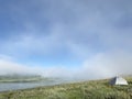 Camping on a lake with early morning fog at crack of dawn Royalty Free Stock Photo
